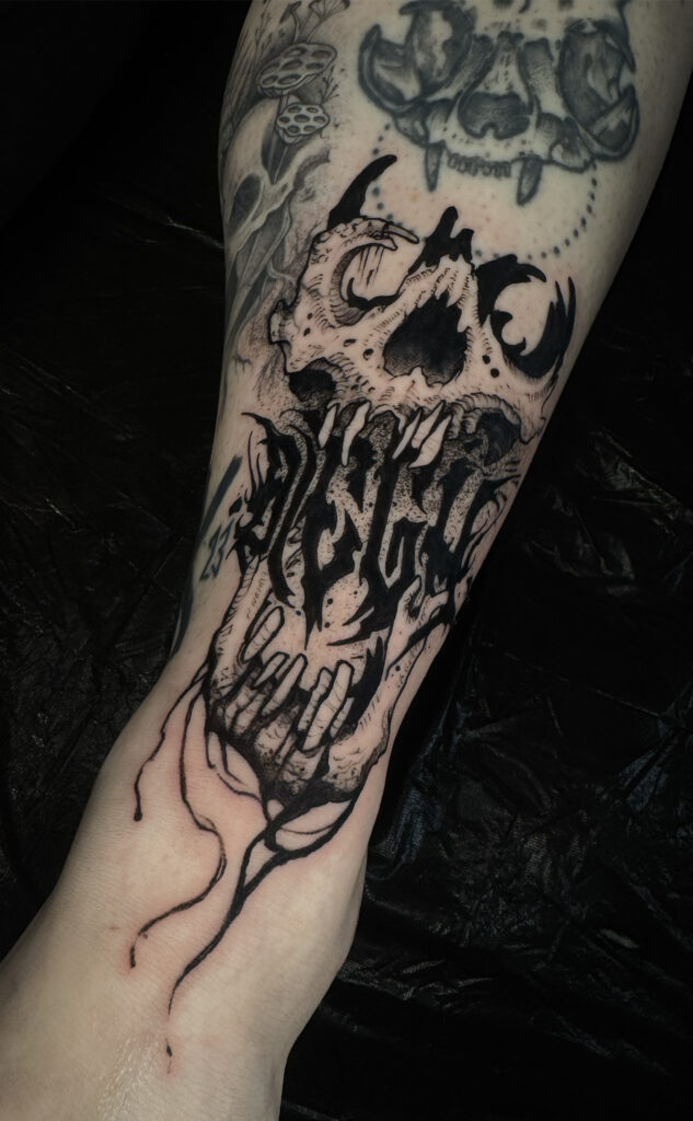 text skull blackwork tattoo